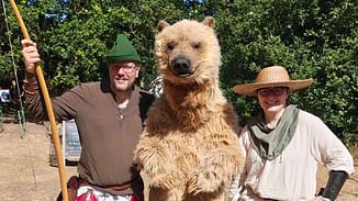 Realistic grizzly bear costume walking through Sherwood Forest
